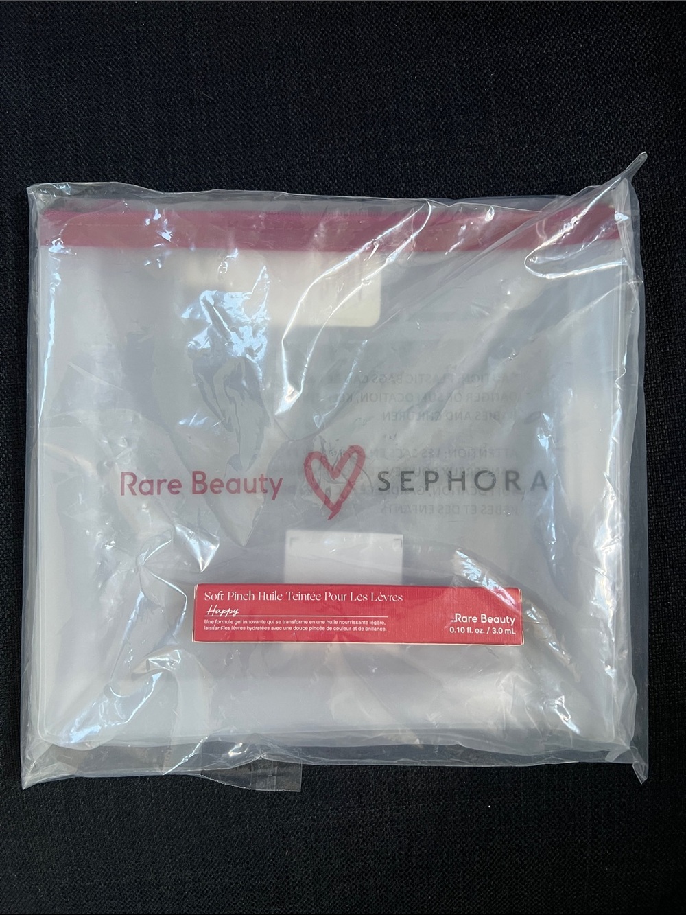 Rare Beauty Soft Pinch Lip Oil Happy with makeup pouch